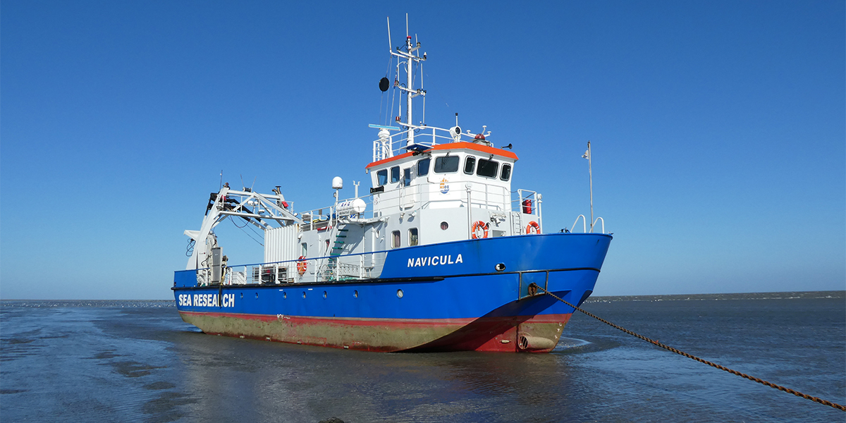 RV Navicula on the mudflats at low tide