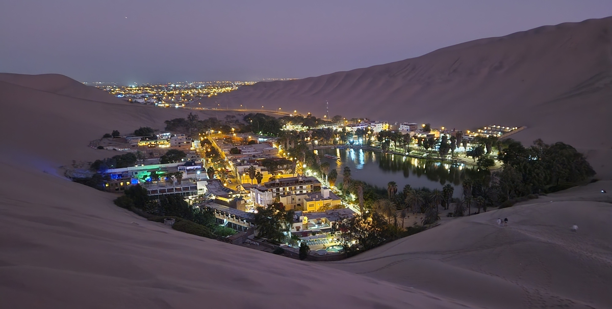 Huacachina oasis during twilight; even more beautiful! In the background the city of Ica