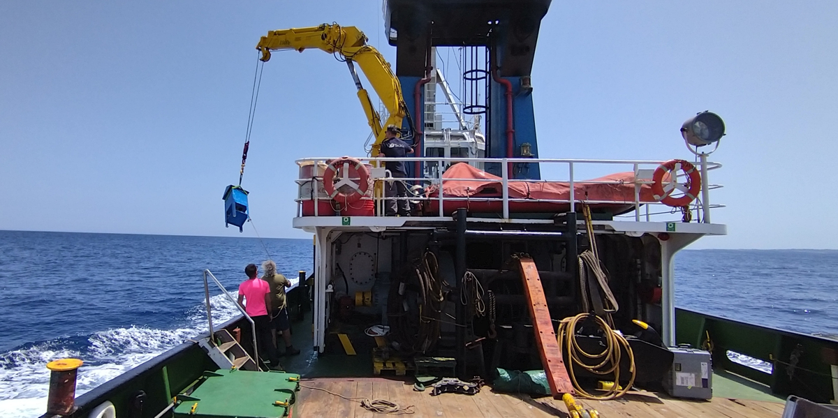 Using the ship's crane, the dust collectors are transported towards the front of the ship.