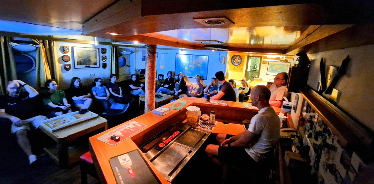 The cosy Pelagia bar is filled with both cruise participants and crew