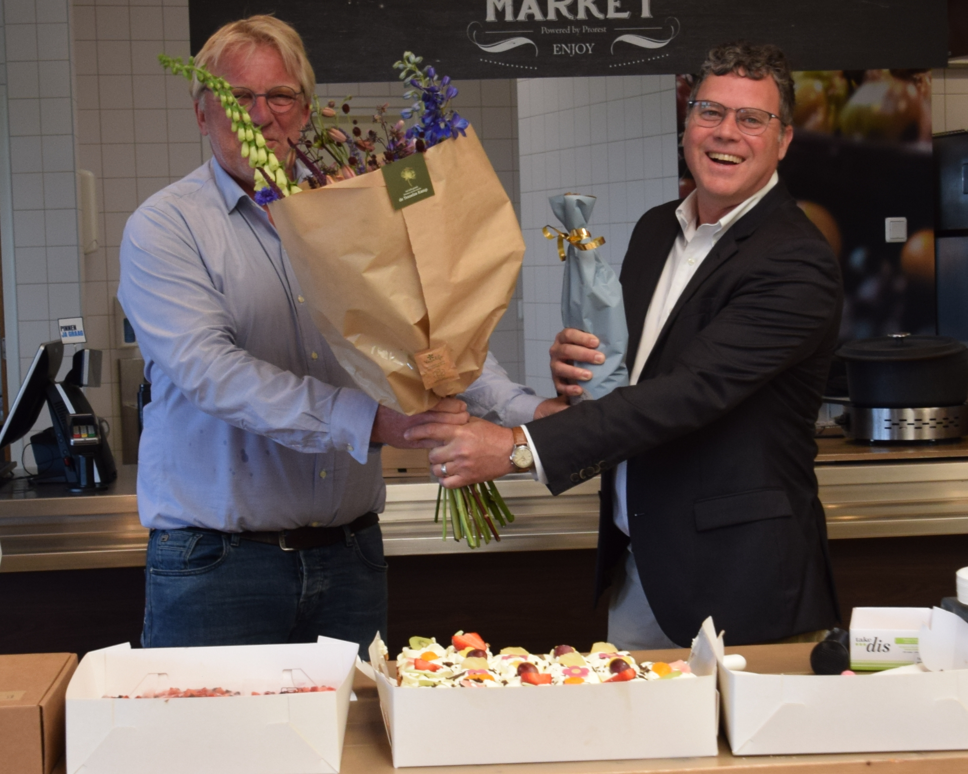 Han Dolman offers flowers and bubbles to Myron Peck. Photo: NIOZ