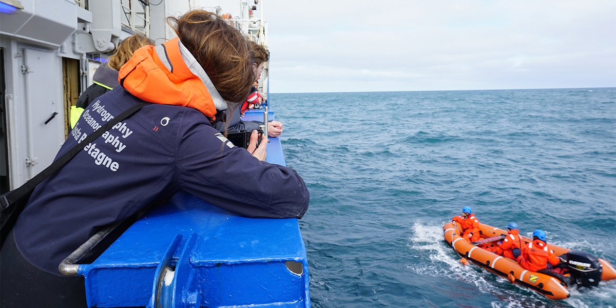 Photo: Isabela Le Bras, in the Neil Armstrong small boat, brings gift. Credit: Fleur Wellen