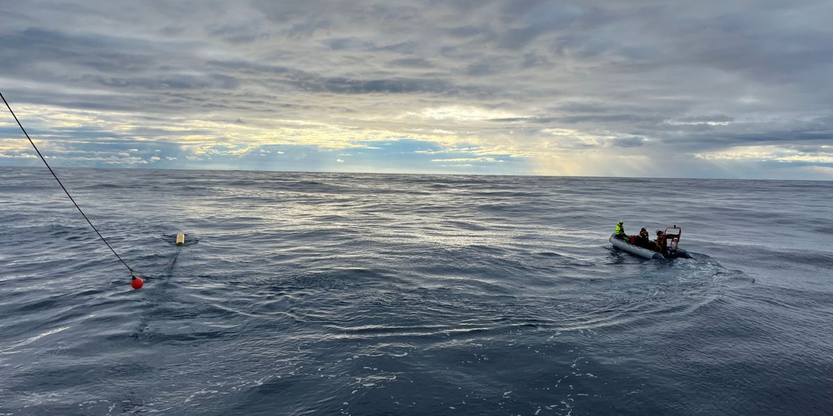 Small working boat just after having picked up the top-buoy of the vertical line at the surface and attached it to R/V Pelagia winch-line. 