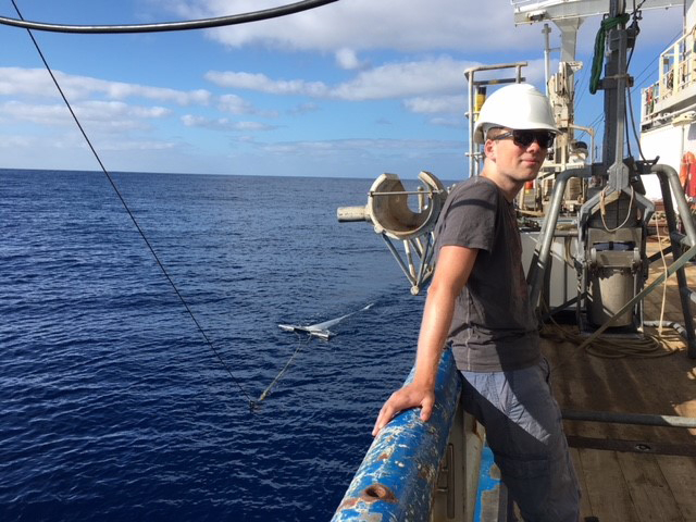 Victor Onink (Netherlands) with two of the key instruments used on the Microplastics Transit Voyage:  A Manta Trawl Net on the left and a Box Corer on the right. 