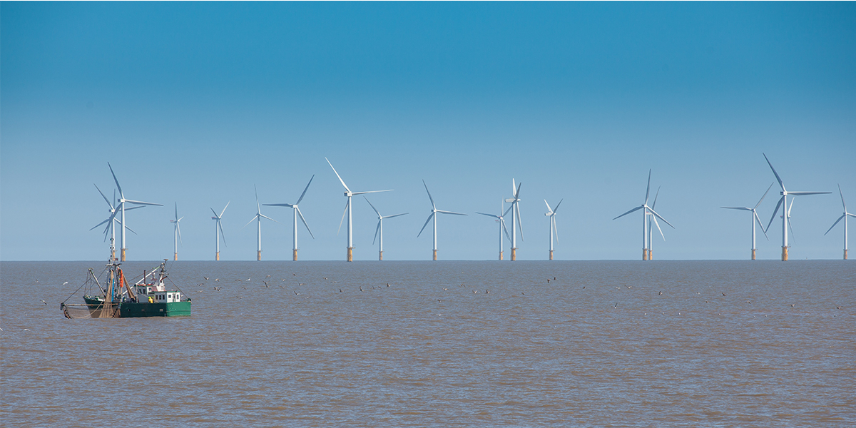 UK off shore wind turbine and fishing boat. Photo: ShaunWilkinson/Shutterstock.com 