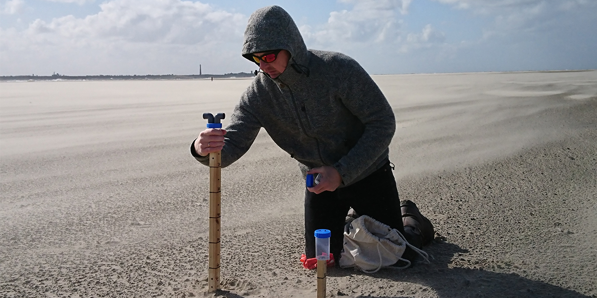 Jan-Berend Stuut collecting wind-blown sands on the island of Texel to try and deduce relationships between aeolian transport and the physical properties of the wind-blown particles.