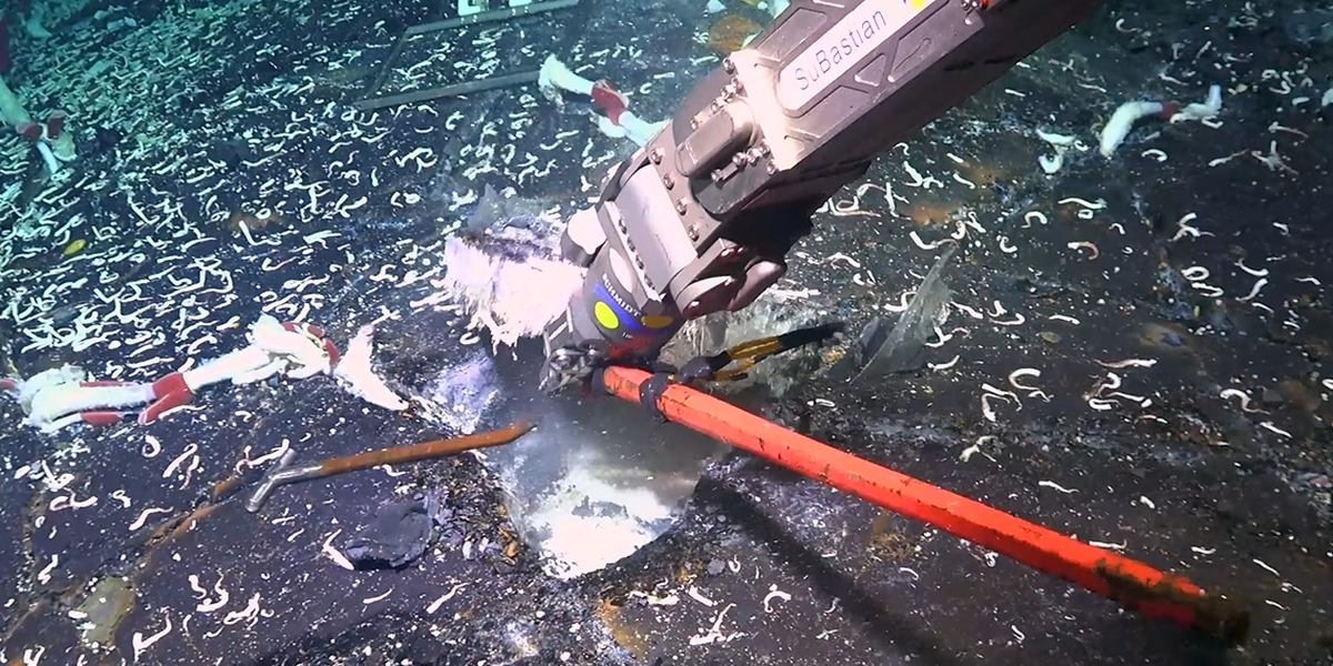 Breaking open the rocks at the Tica Vent​​. Photo: ROV SuBastian / Schmidt Ocean Institute​.