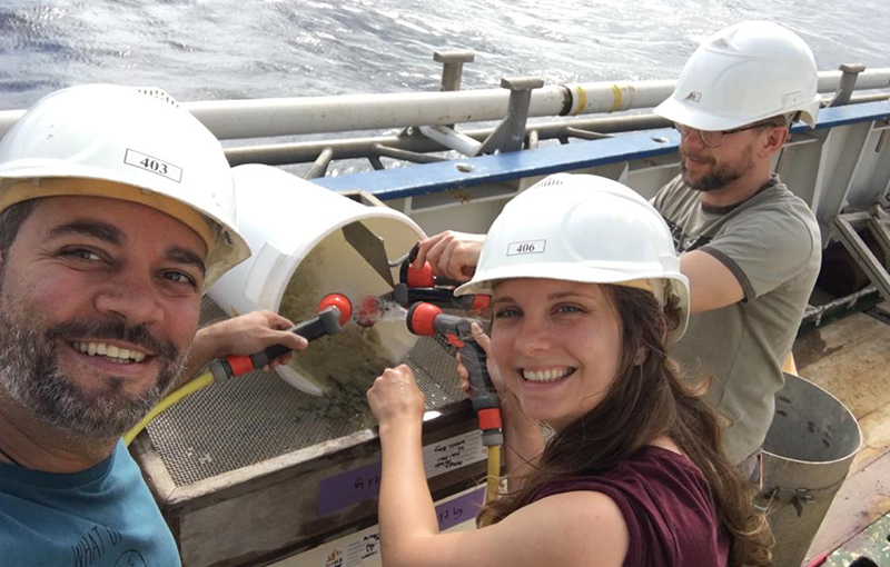 Box-core with olive black sandy mud sediments containing coral fragments and associated organisms being sieved by Rodrigo, Kristin and Jürgen (from left to right).