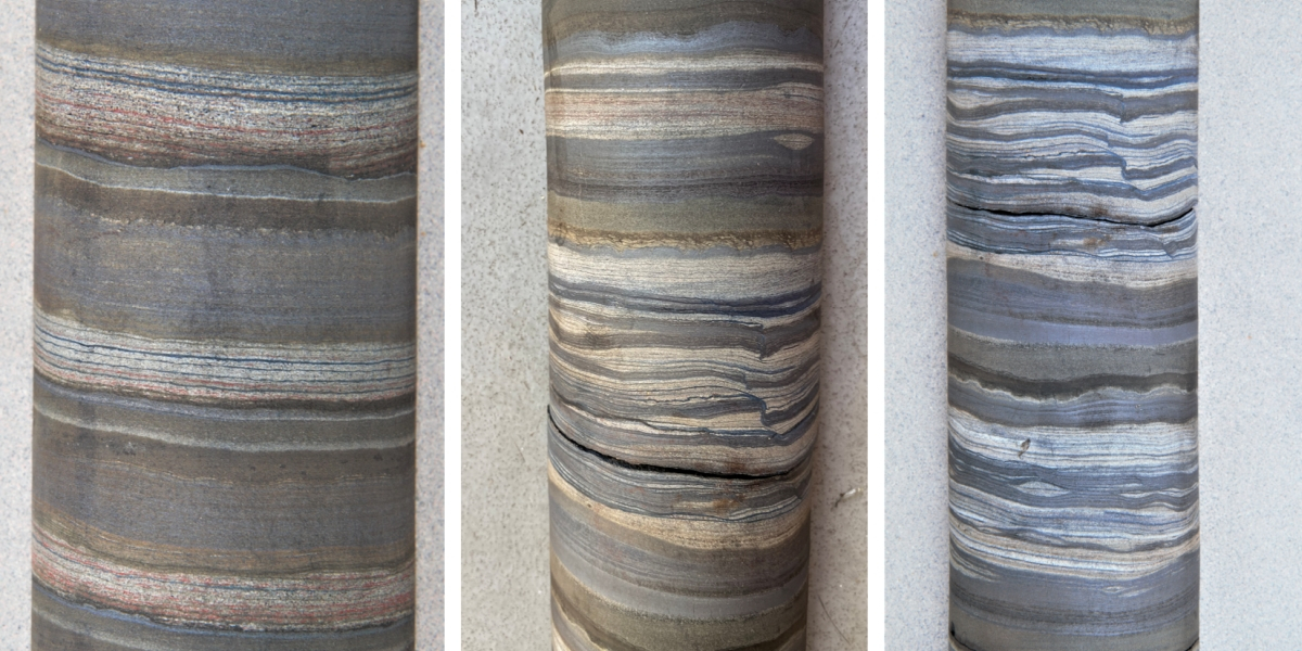 Drill cores from 2.46-billion-year-old banded iron formations. Regular alternations are visable between calcareous clays (green-brown colors), iron oxide (silvery blue) and flint (white to light beige).