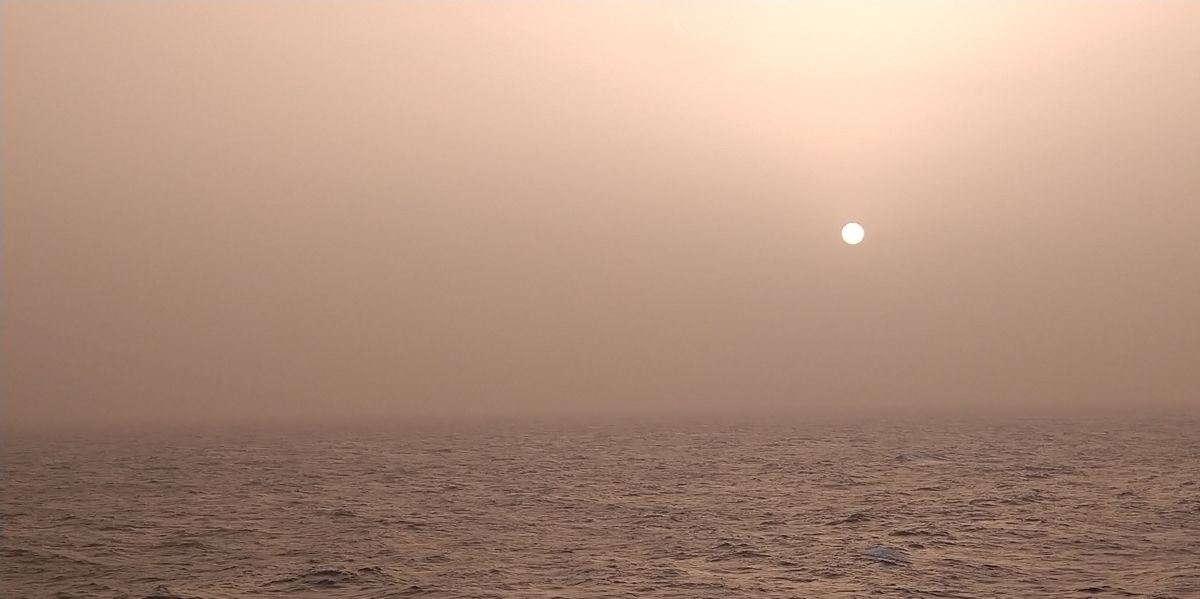 A dusty sunset over the equatorial North Atlantic Ocean