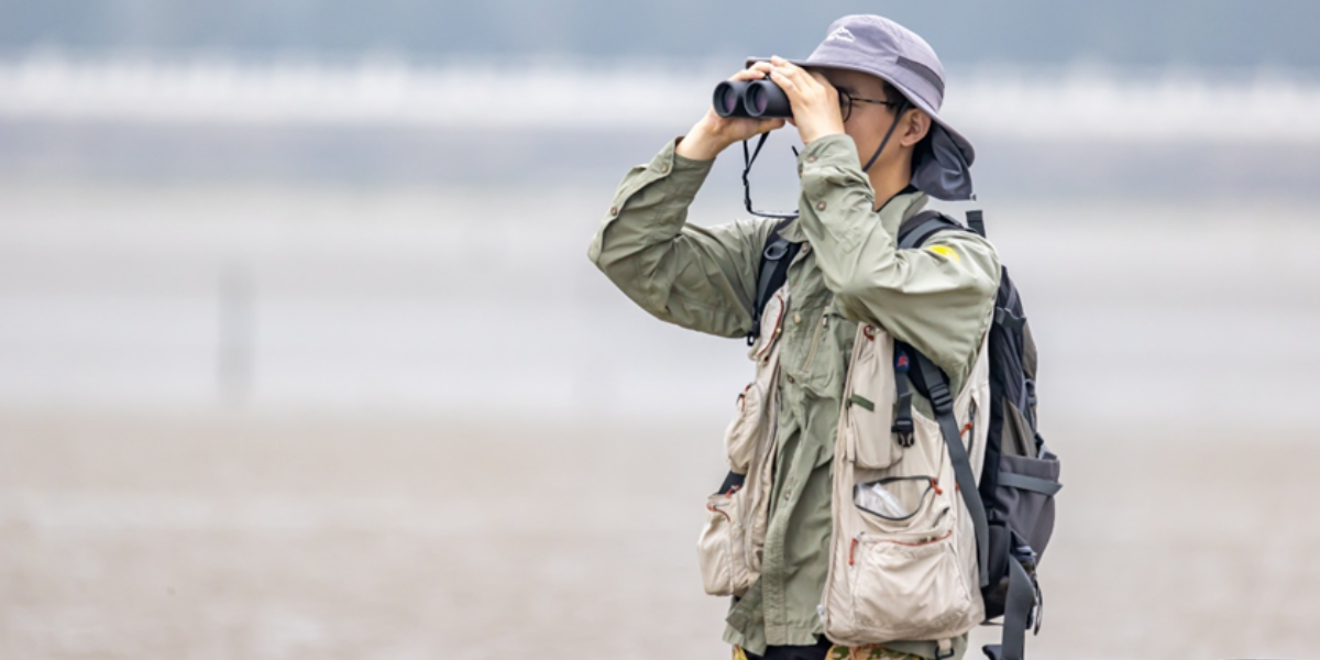 Hebo Peng is observing the birds. Credits: Hanming Tu