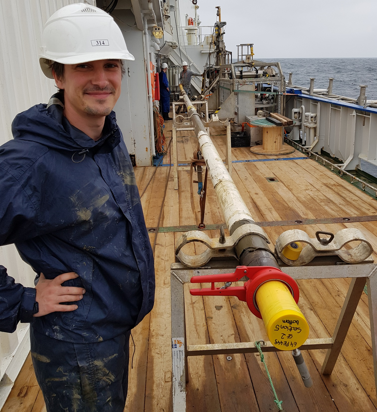 Getting ready to cut a piston core into several sections on R/V Pelagia.