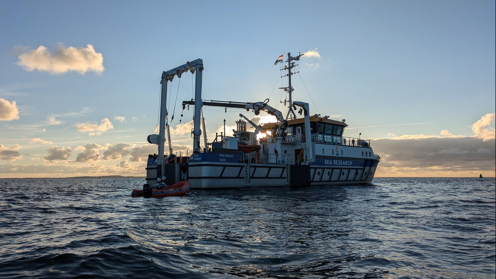 The ship RV Wim Wolff seen while sailing on a quiet sea, just before sunset
