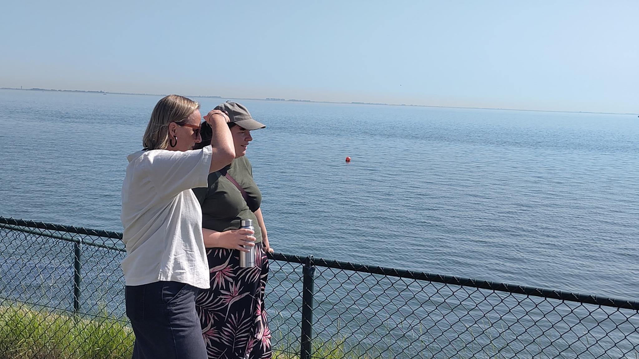 Two women looking across the water