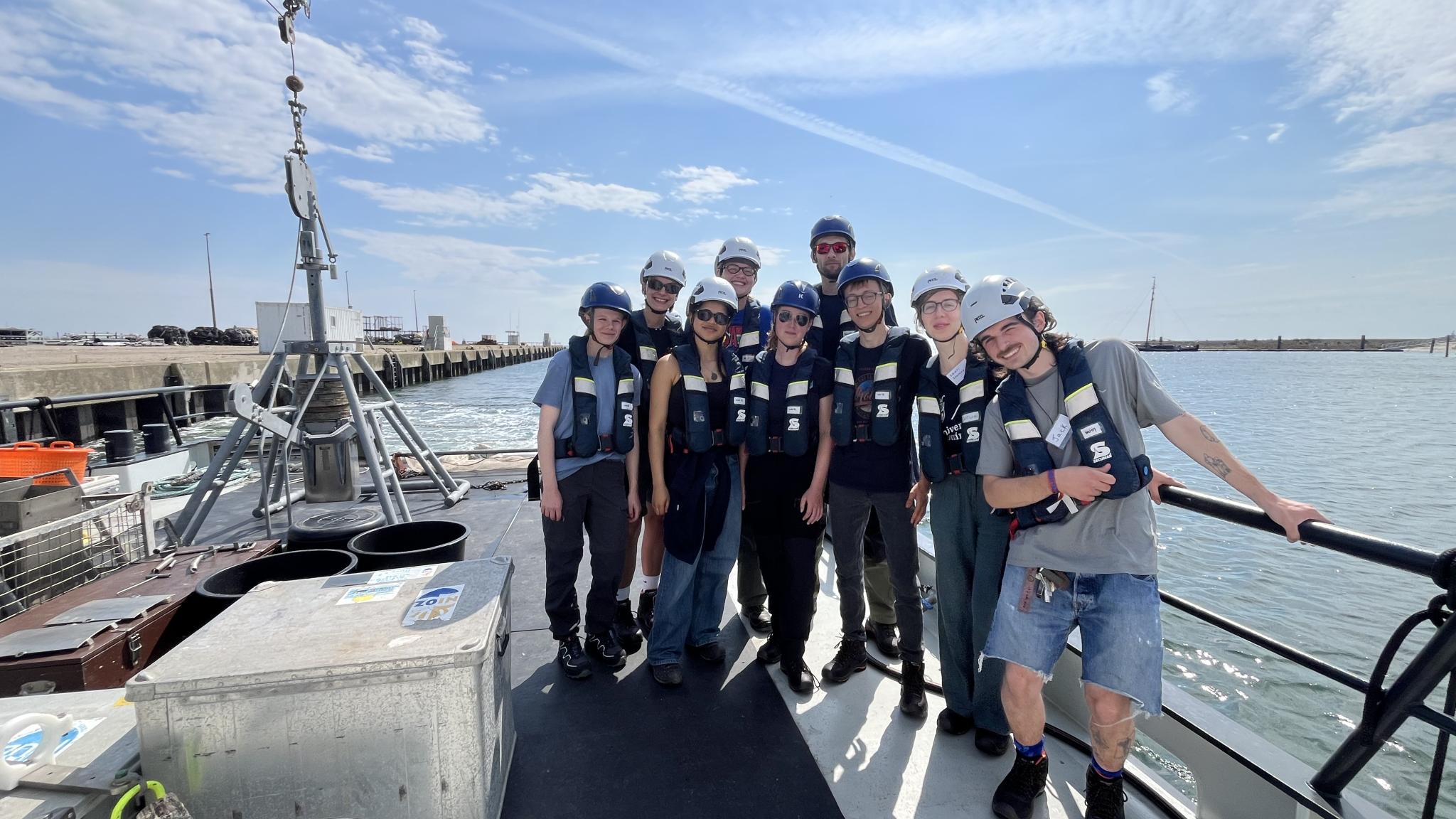 A group of students in safety gear on the rear deck of the RV Wim Wolff