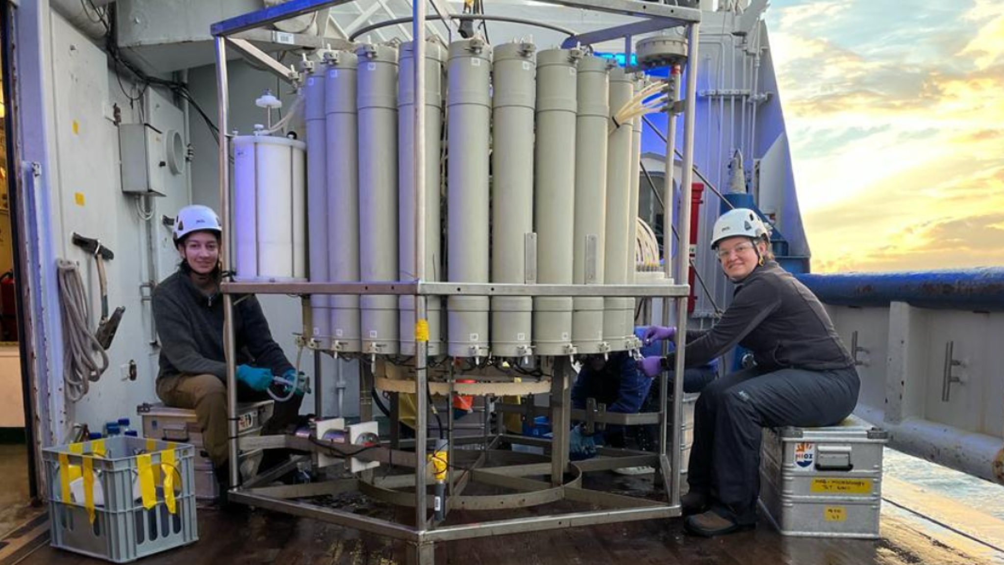 two persons with large research tool on board