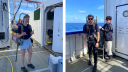 Two people carry backpacks with water samples on board