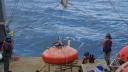 Preparation on deck of a research vessel of an orange mooring to be deployed into the blue ocean