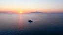 The ship in front of the Etna during sunset