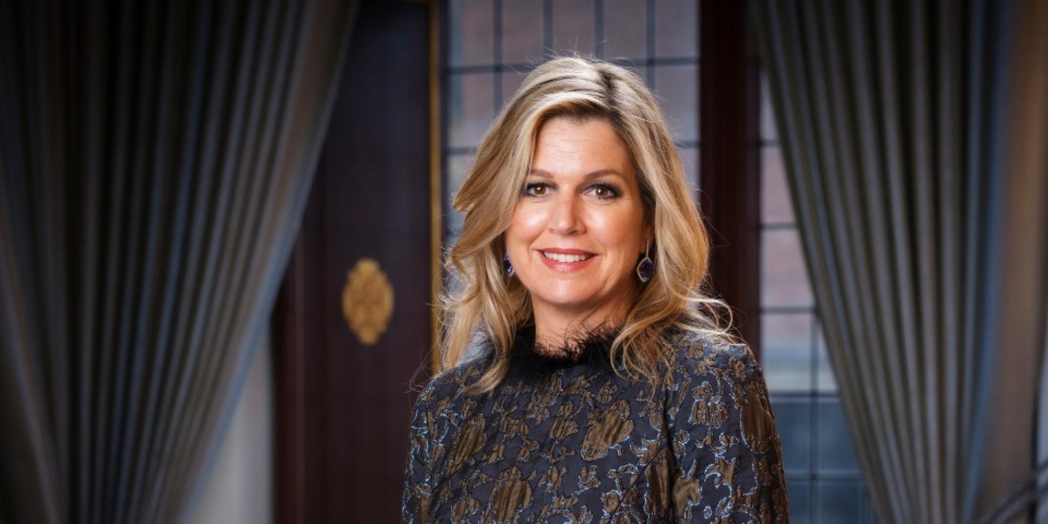Queen Maxima posing in a ballroom