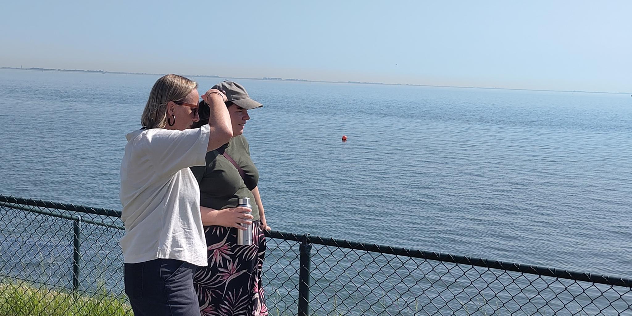 Two women looking across the water