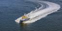 Small research vessel making a quick turn, photographed from the air