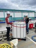 Setting up the ‘plankton pump’ on the aft deck to collect surface ocean plankton.