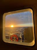 Sunset viewed through a cabin window aboard the research vessel in the Irminger Sea.