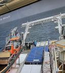 Camera footage on a monitor showing the aft deck and winch during deployment of the multinet.