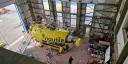 A photo of the submersible Nautile in the IFREMER workshop: a yellow submarine hoisted up for repairs